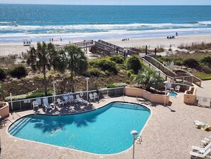 A pool area with a view of the beach and ocean. - Cambridge 410 - Beautiful Condo in Litchfield by the Sea (Pawleys Island)