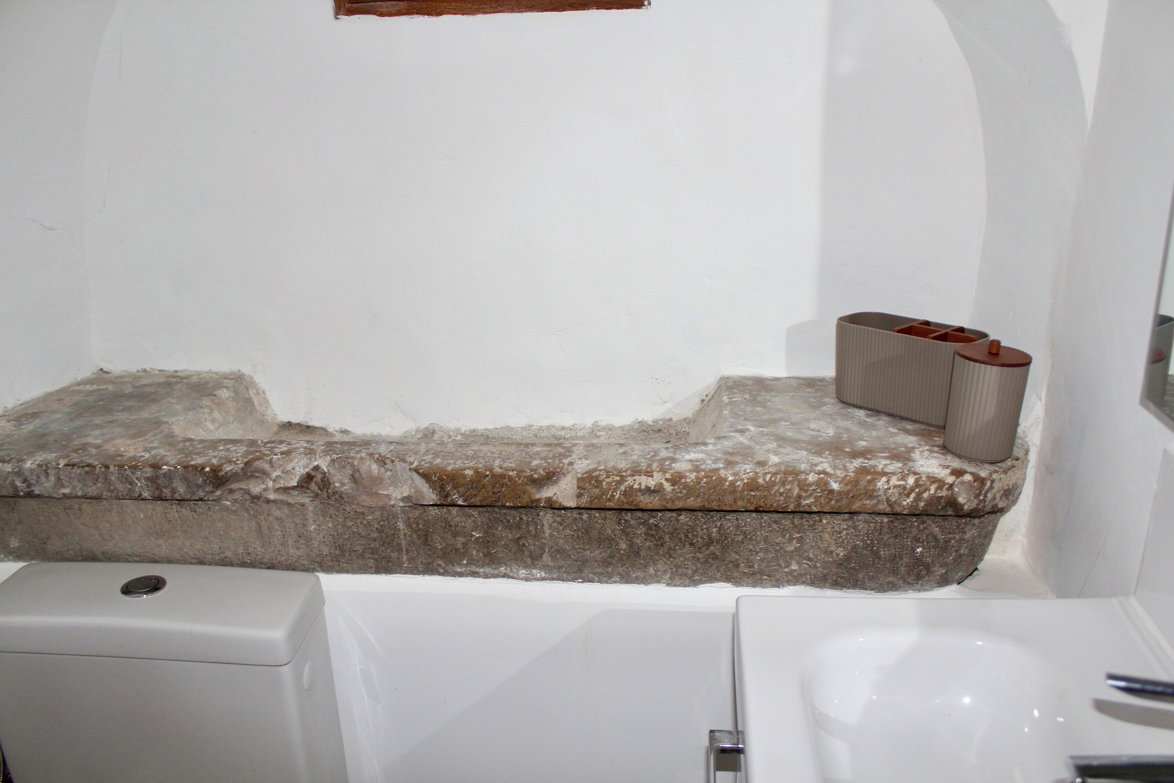 A bathroom with a bathtub, a toilet, and a sink.