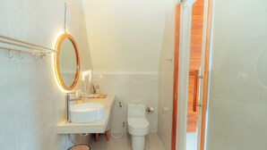 A bathroom with a toilet, sink, and mirror. - Svargan Lakeside Glamping & Restaurant (Baturiti)