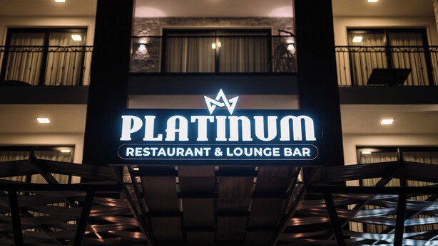 A sign for 'PLATINUM Restaurant & Lounge Bar' with a star logo.