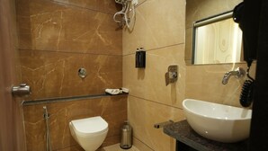 A bathroom with a toilet, sink, and shower. - Privilon Hotel Prahladnagar (Ahmedabad)