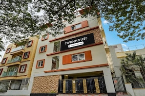 Un edifici de diverses plantes amb un rètol que diu 'TOWNHOUSE Company-Serviced'.