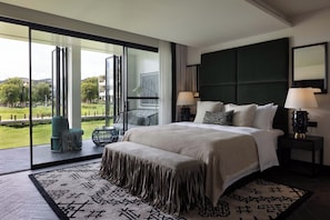 A modern hotel room with a large bed, two bedside tables with lamps, a view of the outdoors, and a large window. - Arcadia Small courtyard (Dali)