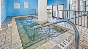 A pool area with clear water, a 3FT no diving sign, and a metal railing. - Oceanfront Two Queen Room + Beach + Dog Friendly (Myrtle Beach)