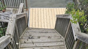 A wooden staircase leading to a dock over water. - Luxe waterfront cottage with a private dome (Whitchurch-Stouffville)