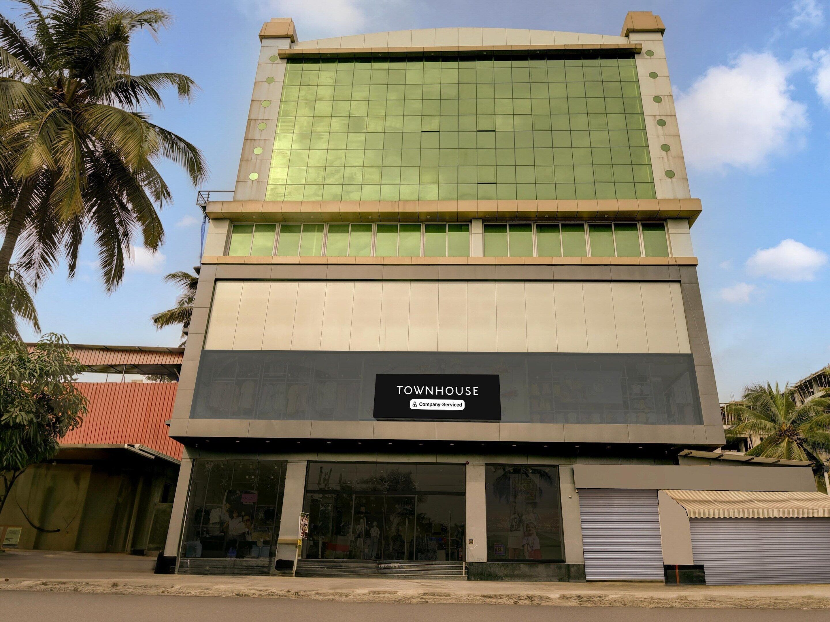 A building with a sign reading 'TOYNHOUSE' and a glass facade.