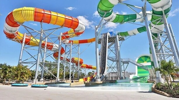 A water park with multiple water slides and a pool area. - Waterfront Cottage • Margaritaville Resort - Prime Disney Area! (Kissimmee)