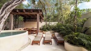 A poolside area with lounge chairs, a hot tub, and a pergola. - Modern ground-level 3BR Retreat with Private Pool (Tulum)