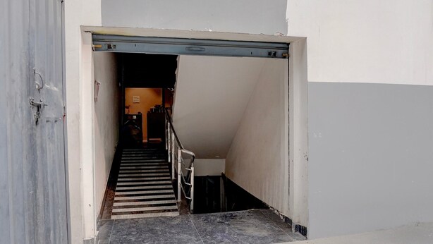 A stairway leading to an upper floor with a metal handrail and a door at the top. - Deluxesriman Stay INN (Hyderabad)