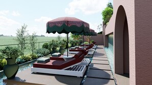 A poolside area with lounge chairs, umbrellas, and potted plants. - Villa Verdejo Luxury 2-Bedroom, 2-Bathroom Apartment with Pool & Spa (Olivella)