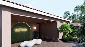 A modern building entrance with a sign reading 'Villa Verdejo Sitios.' - Villa Verdejo Luxury 2-Bedroom, 2-Bathroom Apartment with Pool & Spa (Olivella)