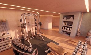 A gym with weightlifting equipment, kettlebells, and a bench. - Villa Verdejo Luxury 2-Bedroom, 2-Bathroom Apartment with Pool & Spa (Olivella)