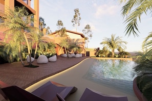 A pool area with lounge chairs, palm trees, and a building with a modern design. - Villa Verdejo Barcelona Loft Penthouse: 2 bedrooms, 2 bathrooms, and a jacuzzi (Olivella)