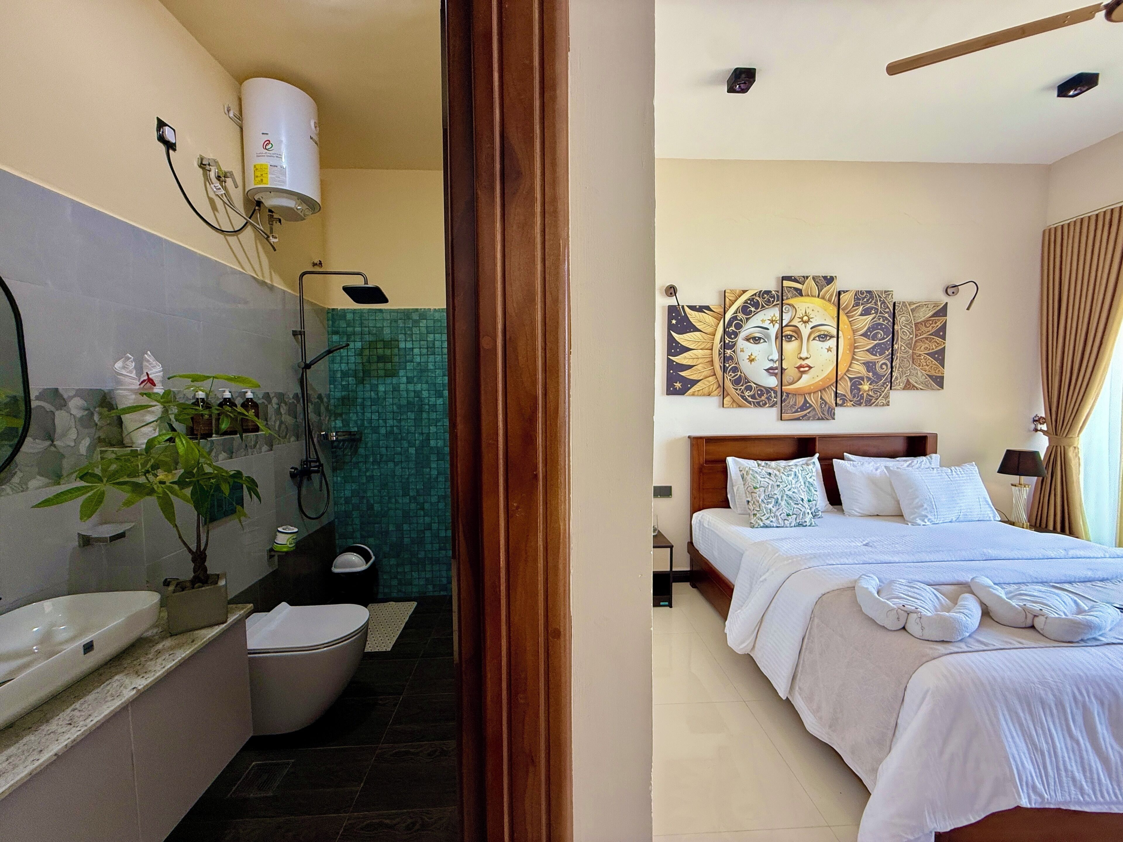 A bathroom with a sink, toilet, shower, and a mirror.