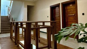A modern interior with a skylight, wooden staircase, and a plant.