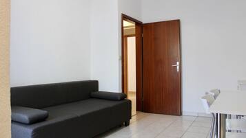 Apartment (Comfort One Bedroom Apartment with Ba) | Living room | 32-inch flat-screen TV with satellite channels