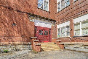 A red brick building with a red door, stone steps, and white windows. - Warrior Trail Access! Converted Schoolhouse Suite (Gary)
