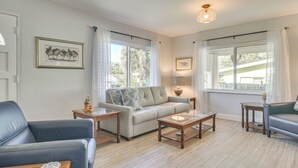 A living room with a sofa, two armchairs, a coffee table, and a lamp. - Beach-hop, Bike & Bbq! Clearwater Home w/ Yard (Clearwater)