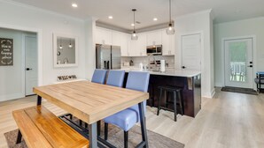 A modern kitchen with white cabinets, stainless steel appliances, and pendant lighting. - New! Foley Family Escape w/ Fenced Yard (Foley)