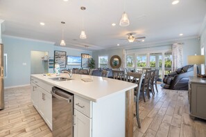 A spacious kitchen with a large island, modern appliances, and pendant lighting. - Introducing Shells N Sea Beach Villa at Lost Key Golf & Beach Club! 4BR 4BA (Pensacola)