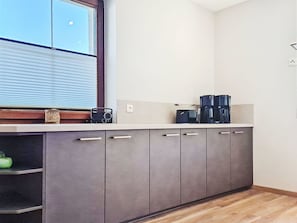 A kitchen with a window, cabinets, and a countertop with a coffee maker. - Wonderful private villa for 12 people with WIFI, TV, balcony and panoramic view (Mittersill)