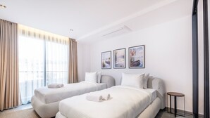 A hotel room with two beds, a small side table, and a large window with curtains. - Bovilla Hotel Sentio Yalıkavak (Bodrum)
