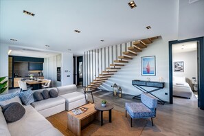 A modern living room with a staircase, a dining area, and a bedroom. - Bovilla Hotel Sentio Yalıkavak (Bodrum)