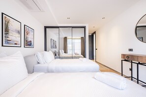 A modern hotel room with a large bed, a bedside table, a mirror, and two framed pictures on the wall. - Bovilla Hotel Sentio Yalıkavak (Bodrum)