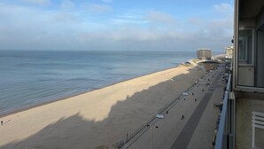 A beach with a promenade, a distinctive building, and the ocean. - Apartment With sea View in Middelkerke for 6 (Middelkerke)
