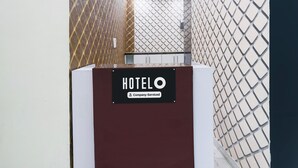 A reception desk with a sign reading 'HOTELO' and 'Company-Serviced.' - Deluxe Hotel Paradise Peak (Kanpur)