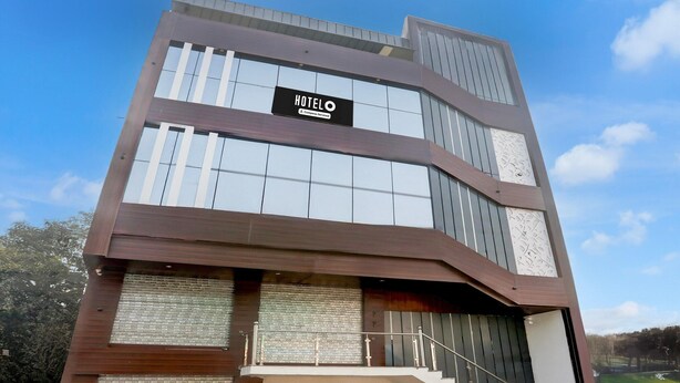 A modern hotel building with a prominent sign reading 'HOTELO.' - Deluxe Hotel Paradise Peak (Kanpur)