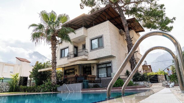 A modern two-story house with a swimming pool, surrounded by greenery and mountains. - 6 Rooms Stone Villa With Private Pool - Sea and Mountain Views (Kemer)