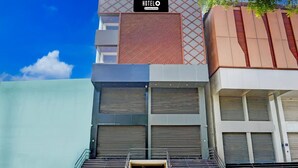 Un hotel con fachada moderna, un letrero llamativo y una escalera que conduce a la entrada.