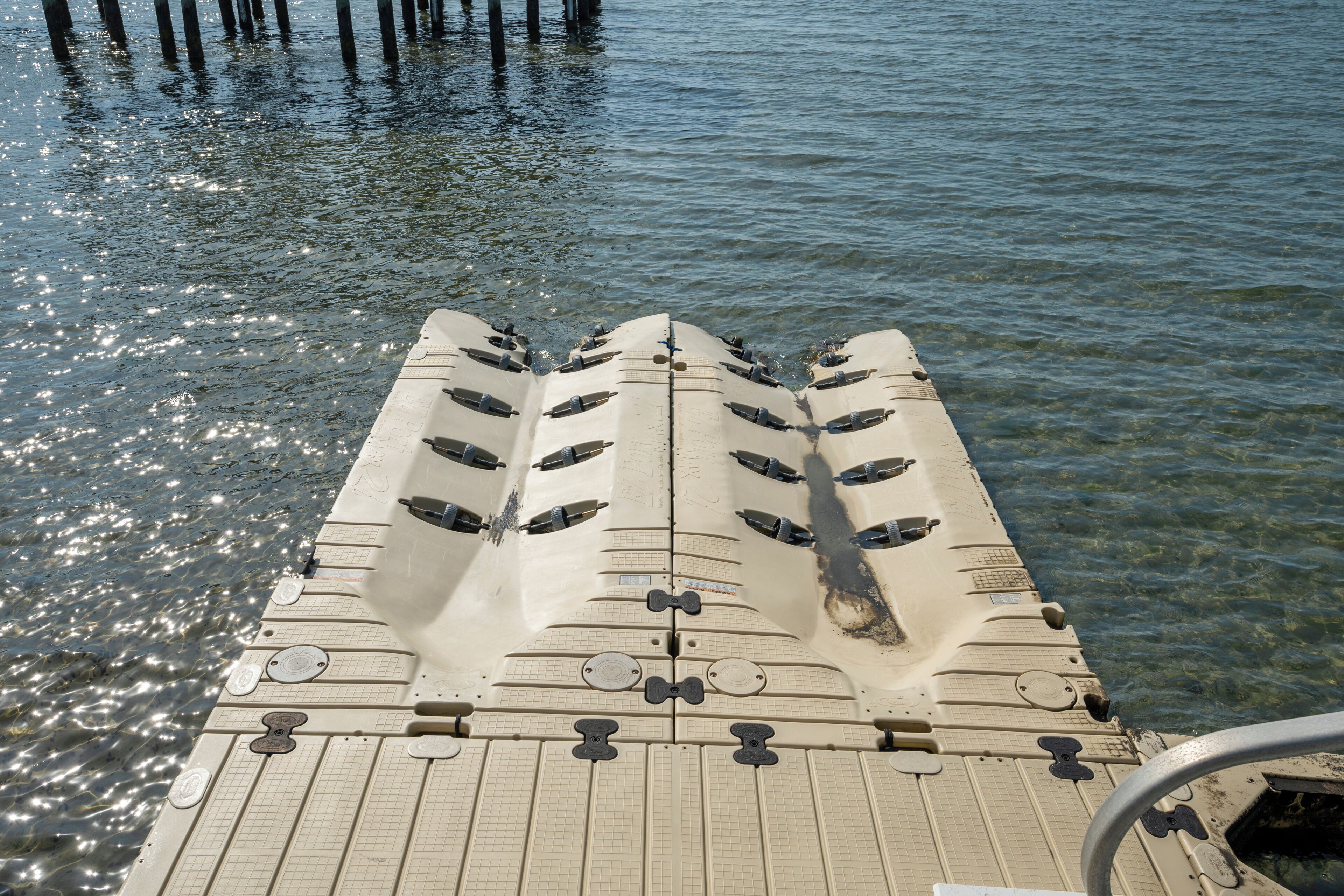A boat's deck with seating and a railing.