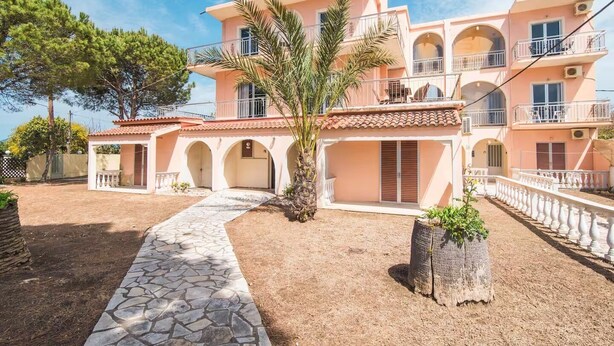 A multi-story building with balconies, a stone pathway, and a palm tree. - Southgate 3 by MPS (Agios Georgios)
