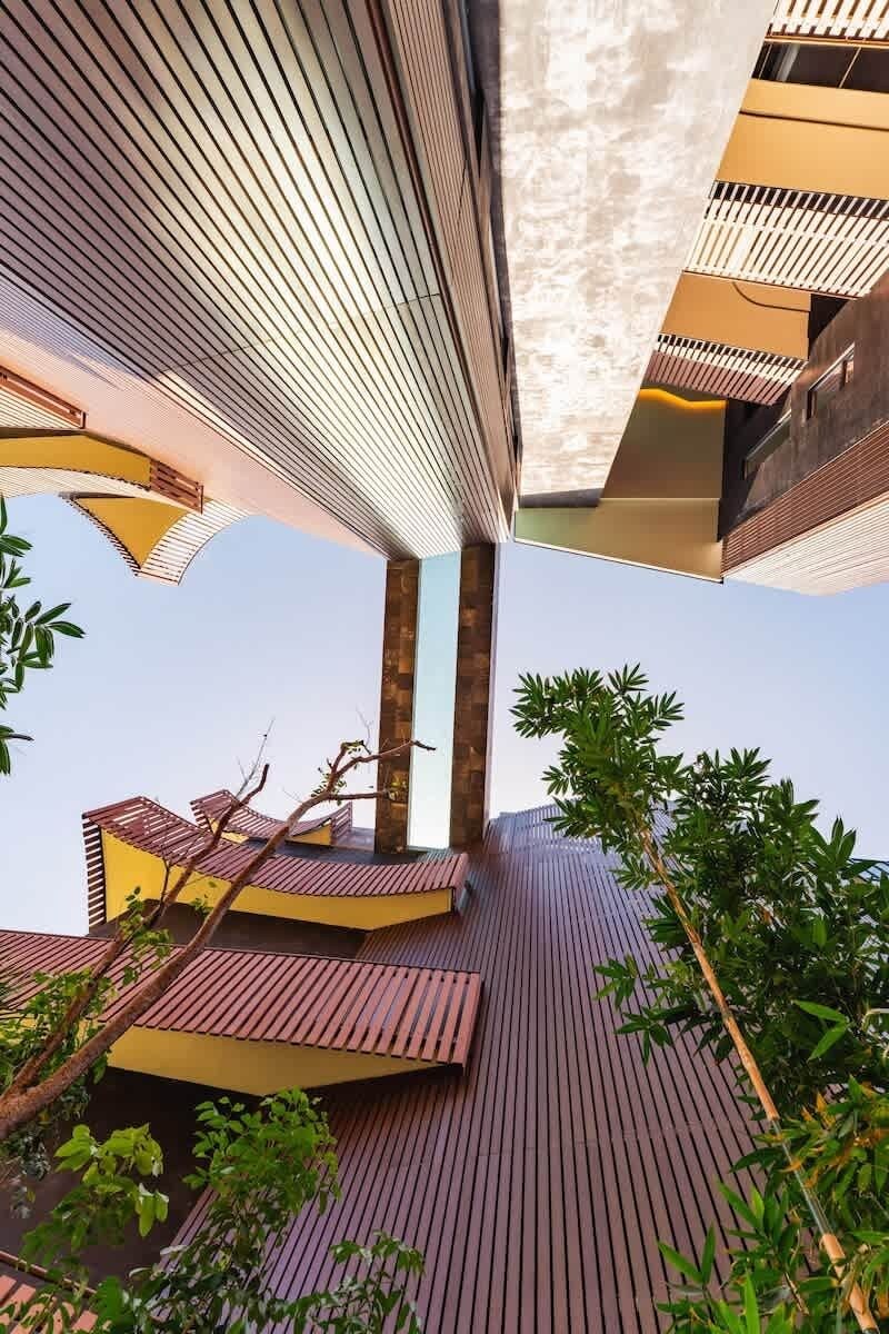 A modern architectural structure with a curved roof and multiple levels.
