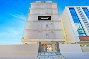 A modern building with a sign reading 'TOWNHOUSE OAK' and a gated entrance. - Deluxe Suchitra Kompally Sun Moon Hotels (Hyderabad)
