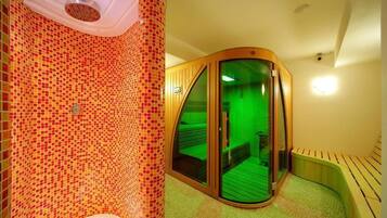 A room with a mosaic-tiled wall, a wooden bench, and a glass door leading to a green-lit space.