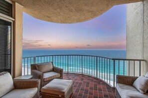 A balcony with wicker furniture and a view of the ocean. - Luxury Gulf Front Condo at Hidden Dunes! 18th Floor! (Miramar Beach)
