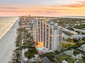 A high-rise hotel with multiple balconies, a swimming pool, and a beach view. - Luxury Gulf Front Condo at Hidden Dunes! 18th Floor! (Miramar Beach)