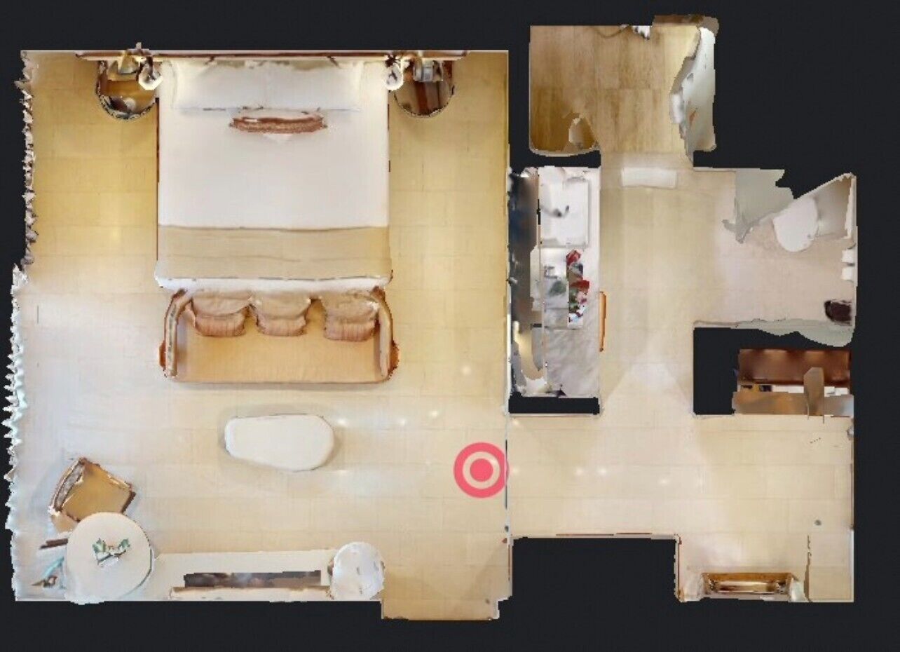 A room with a bed, a small table, and a window.