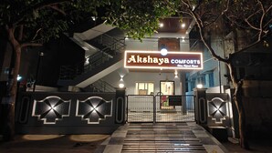 A gated entrance to a building with a sign reading 'Akshaya Comforts.' - AKSHAYA COMFORTS (Visakhapatnam)