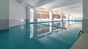 An indoor swimming pool with clear water, tiled walls, and a visible railing. - Annbell Haven 1br, With Pool, Near Junct (Nairobi)