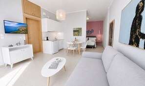 A modern apartment with a kitchen, dining area, and living room. - Art Apartment | 80m from the Beach with Balcony & Private Parking (Palaiochora)