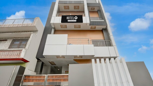 A multi-story hotel with a prominent 'HOTEL O' sign, balconies, and a modern architectural design. - Super Deluxe Room Mohini Guest House (Bareilly)