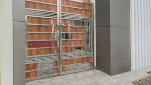 A double metal gate with wooden panels and a metal handle. - Super Deluxe Room Mohini Guest House (Bareilly)