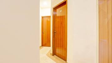 A hallway with wooden doors, numbered 101 and 103, leading to rooms.