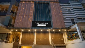 A modern building with a sign reading 'TOWNHOUSE' and a staircase leading to the entrance. - Deluxeamba Palace (Prayagraj)