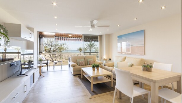 A modern living room with a large window, a dining area, and a kitchen. - Luxury vacations in Bermuda Apartments in front of the beach - ONLY FAMILIES (Playa de Gandía)