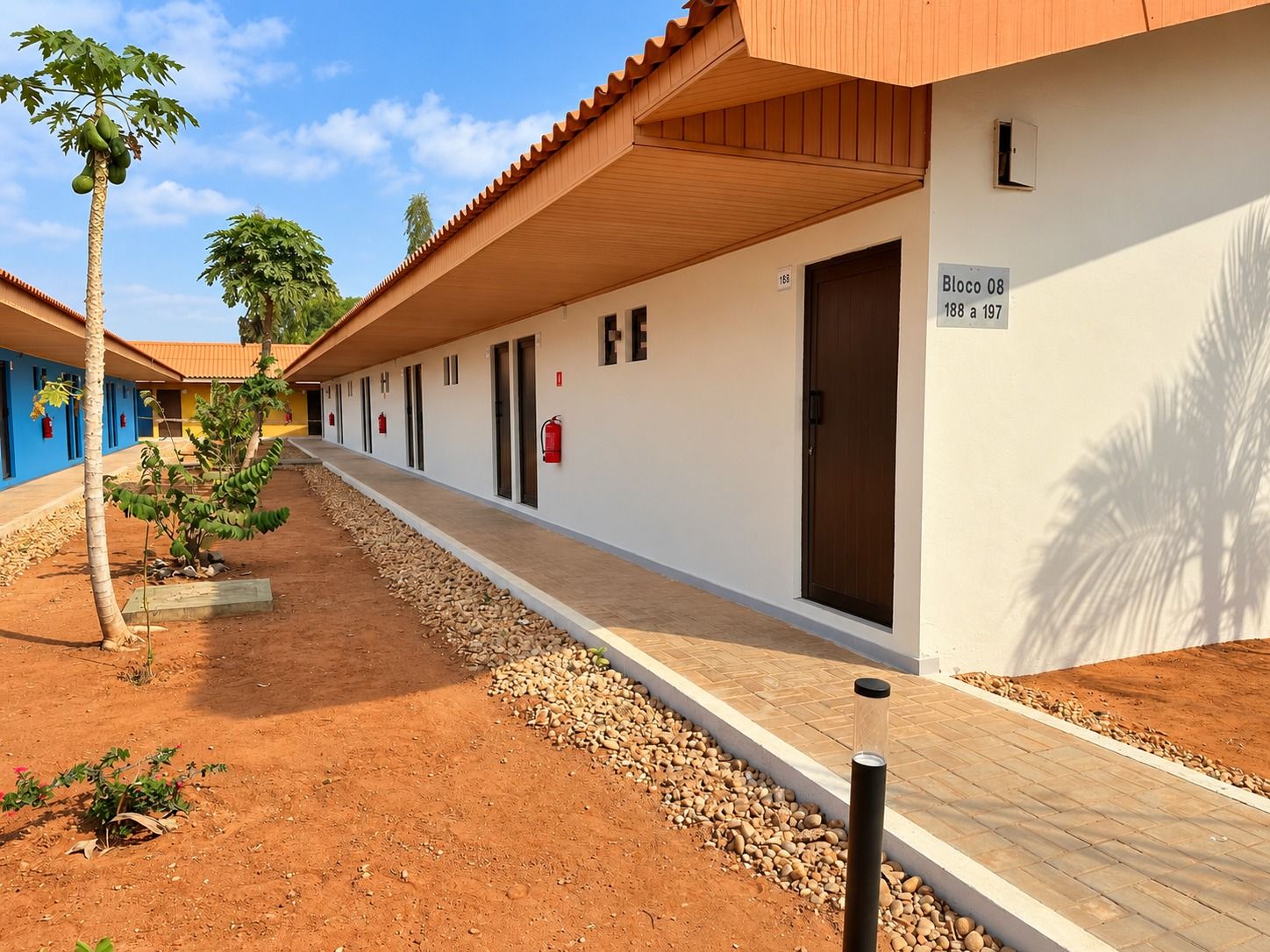 A hotel corridor with multiple rooms, a wooden ceiling, and a sign indicating room numbers.
